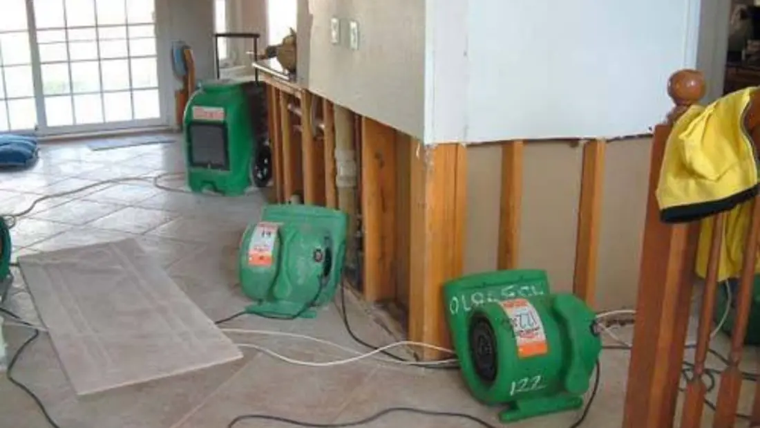 Air movers running in a room where wet drywall was cut out