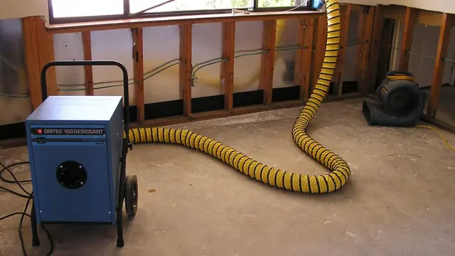 Dehumidifier and ducting drying a room with the lower wall cut open